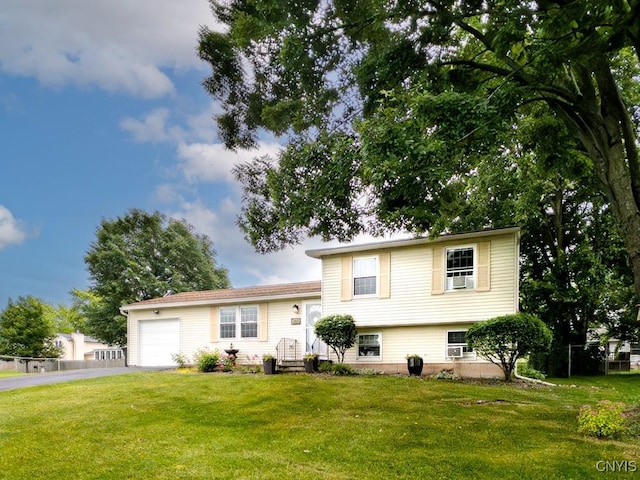 4753 Freestone Rd, Clay, NY 13090 - split level home with driveway, an attached garage, and a front yard
