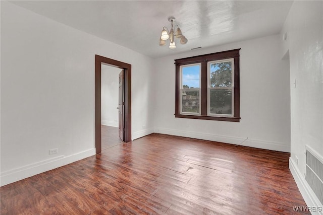 214 Ludington St, Buffalo, NY 14206 - spare room featuring a chandelier and wood finished floors