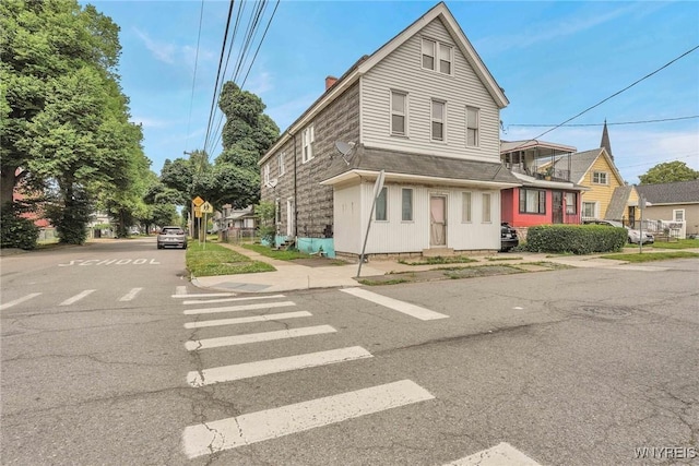 214 Ludington St, Buffalo, NY 14206 - view of front of house featuring a chimney and a shingled roof