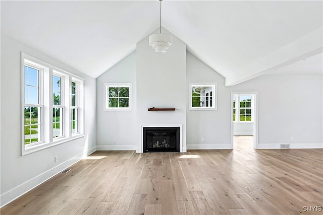 3745 Fisher Rd, Skaneateles, NY 13152 - unfurnished living room with light wood-type flooring, a glass covered fireplace, plenty of natural light, and vaulted ceiling