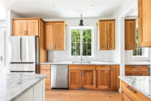 3745 Fisher Rd, Skaneateles, NY 13152 - kitchen with stainless steel appliances, light wood finished floors, backsplash, light stone countertops, and recessed lighting