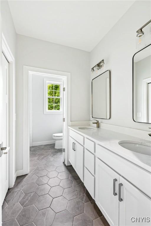 3745 Fisher Rd, Skaneateles, NY 13152 - full bathroom featuring double vanity and toilet