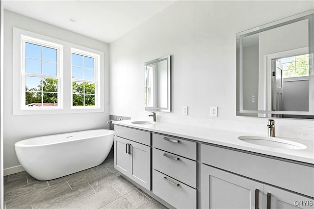 3745 Fisher Rd, Skaneateles, NY 13152 - bathroom featuring double vanity and a freestanding bath