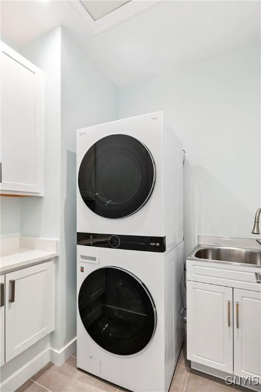 3745 Fisher Rd, Skaneateles, NY 13152 - washroom with stacked washing machine and dryer and cabinet space