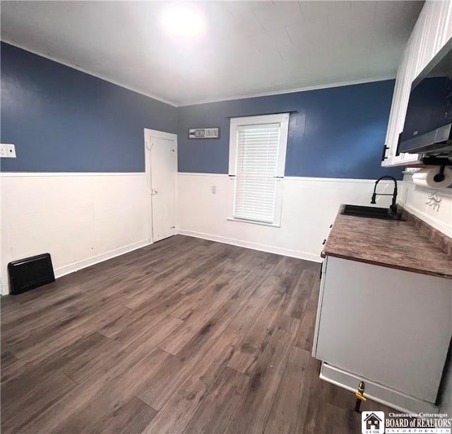 1504 River St, Olean, NY 14760 - unfurnished dining area with dark wood-style floors and wainscoting