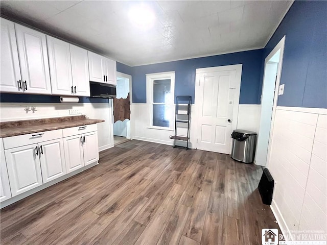 1504 River St, Olean, NY 14760 - kitchen featuring dark countertops, white cabinetry, a wainscoted wall, and dark wood-style floors