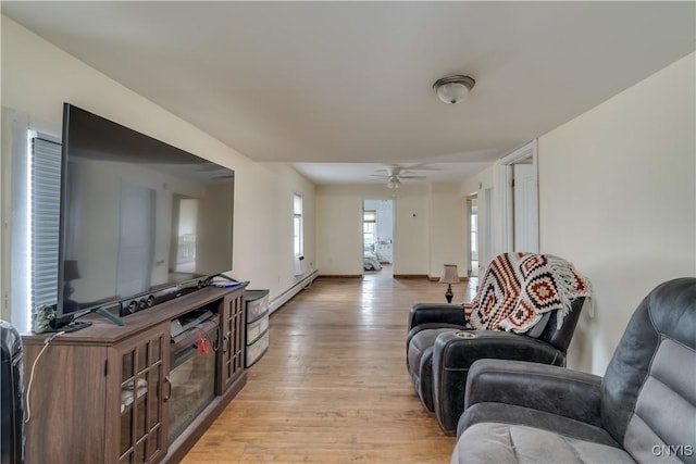 147 Park Ave, Watertown City, NY 13601 - living room with light wood-style floors, a baseboard heating unit, and a ceiling fan