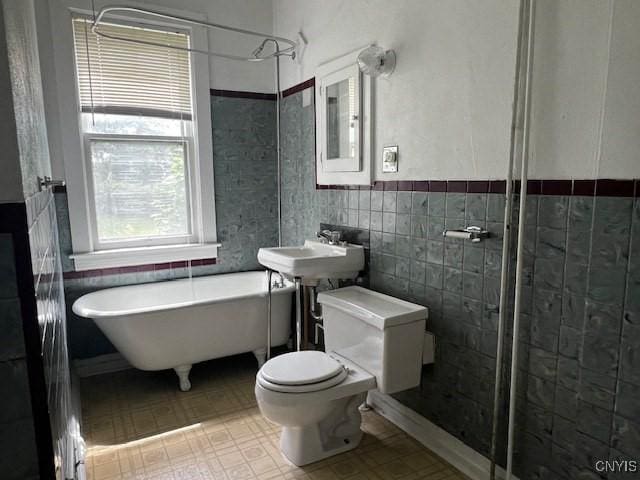1338 Blandina St, Utica, NY 13501 - bathroom featuring a soaking tub, tile walls, a wainscoted wall, and tiled shower