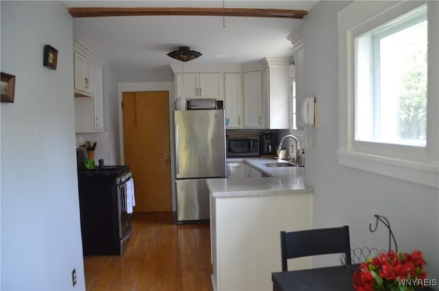 45 Richfield Rd, Amherst, NY 14221 - kitchen with stainless steel appliances, white cabinetry, light countertops, decorative backsplash, and wood finished floors