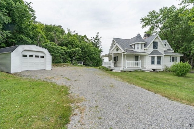 32227 County Route 22, Antwerp, NY 13691 - view of front of property with a porch, a detached garage, gravel driveway, an outdoor structure, and a front lawn