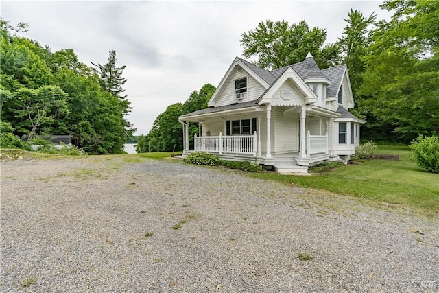 32227 County Route 22, Antwerp, NY 13691 - view of front of home with covered porch, a front lawn, and gravel driveway