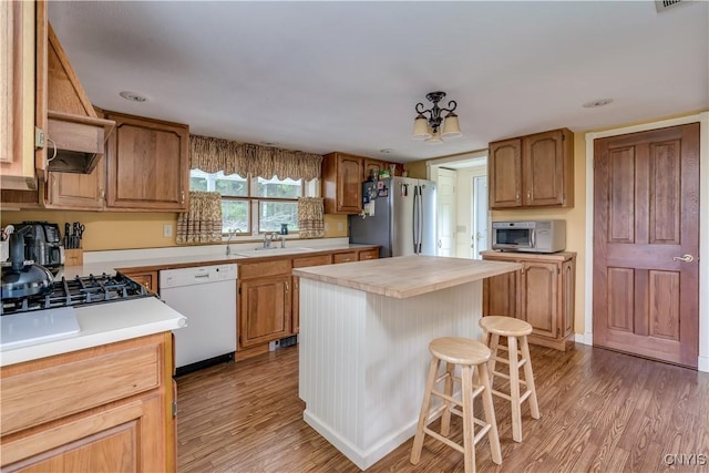 32227 County Route 22, Antwerp, NY 13691 - kitchen with appliances with stainless steel finishes, light wood-type flooring, a kitchen bar, and a kitchen island