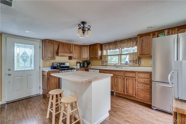 32227 County Route 22, Antwerp, NY 13691 - kitchen with custom range hood, light countertops, light wood-style floors, appliances with stainless steel finishes, and recessed lighting