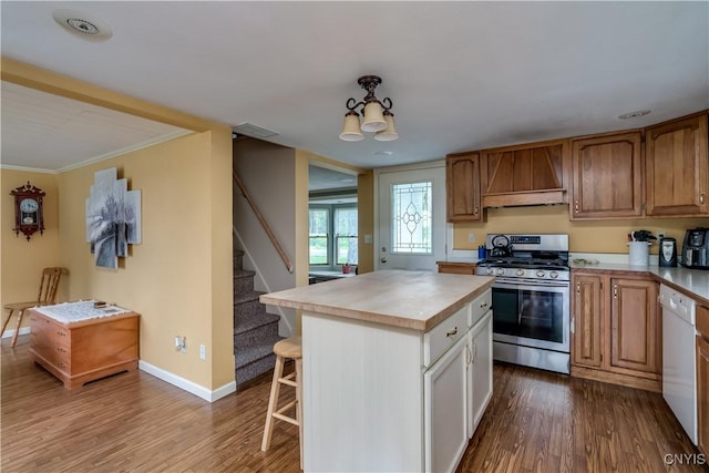 32227 County Route 22, Antwerp, NY 13691 - kitchen with stainless steel range with gas stovetop, white dishwasher, dark wood-style flooring, a kitchen breakfast bar, and a center island