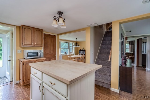 32227 County Route 22, Antwerp, NY 13691 - kitchen featuring a chandelier, stainless steel microwave, wood finished floors, and a kitchen island