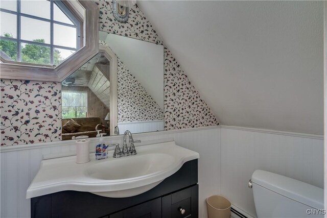 32227 County Route 22, Antwerp, NY 13691 - half bath featuring a wainscoted wall, vaulted ceiling, wallpapered walls, healthy amount of natural light, and vanity