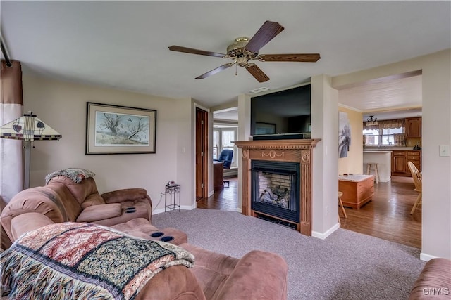 32227 County Route 22, Antwerp, NY 13691 - living room with carpet floors, a ceiling fan, and a fireplace