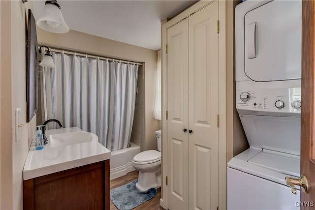 32227 County Route 22, Antwerp, NY 13691 - bathroom with estacked washer and dryer, vanity, shower / bath combo, and wood finished floors