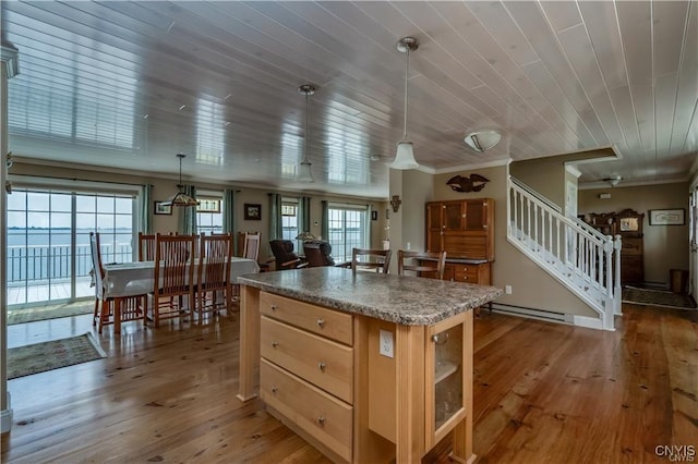 28005/08 Stony Point Rd, Cape Vincent, NY 13618 - kitchen with a baseboard radiator, light wood-type flooring, ornamental molding, a center island, and plenty of natural light