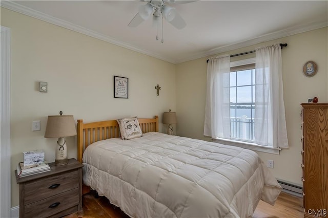 28005/08 Stony Point Rd, Cape Vincent, NY 13618 - bedroom featuring a baseboard heating unit, wood finished floors, ornamental molding, and a ceiling fan