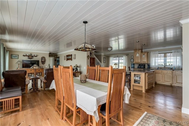 28005/08 Stony Point Rd, Cape Vincent, NY 13618 - dining room with light wood-style floors, stairway, and ornamental molding