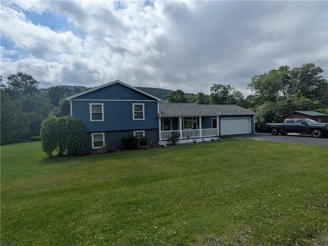 1525 S Ave, Lewis Run, PA 16738 - tri-level home featuring covered porch, asphalt driveway, an attached garage, and a front yard