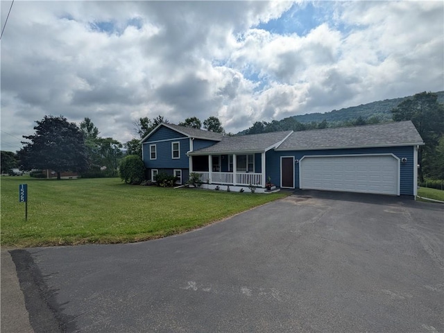 1525 S Ave, Lewis Run, PA 16738 - split level home featuring covered porch, a garage, a front yard, and asphalt driveway
