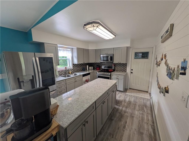1525 S Ave, Lewis Run, PA 16738 - kitchen with stainless steel appliances, gray cabinetry, a kitchen island, tasteful backsplash, and wood finished floors