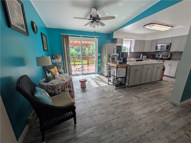 1525 S Ave, Lewis Run, PA 16738 - kitchen with appliances with stainless steel finishes, gray cabinetry, wood finished floors, tasteful backsplash, and vaulted ceiling