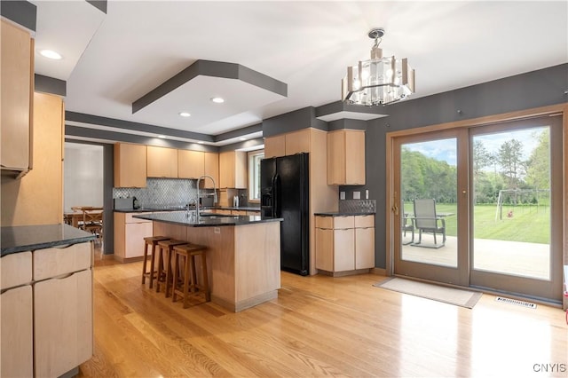 3313 Thompson Rd, Cazenovia, NY 13035 - kitchen featuring black refrigerator with ice dispenser, light brown cabinetry, light wood finished floors, and dark countertops