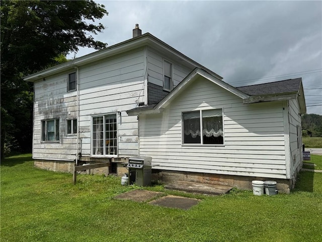 6463 County Road 20, Friendship, NY 14739 - back of house featuring a chimney and a yard