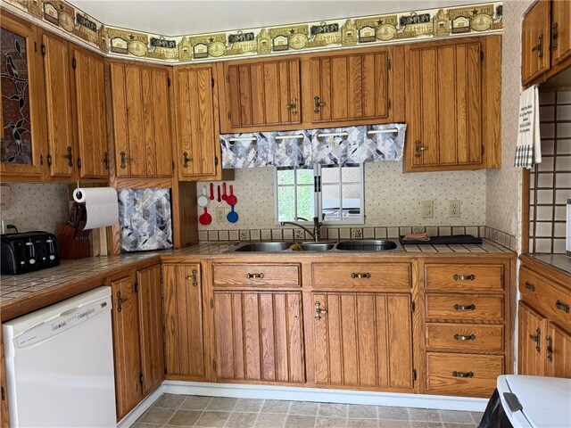6463 County Road 20, Friendship, NY 14739 - kitchen with dishwasher, brown cabinets, tile counters, and wallpapered walls