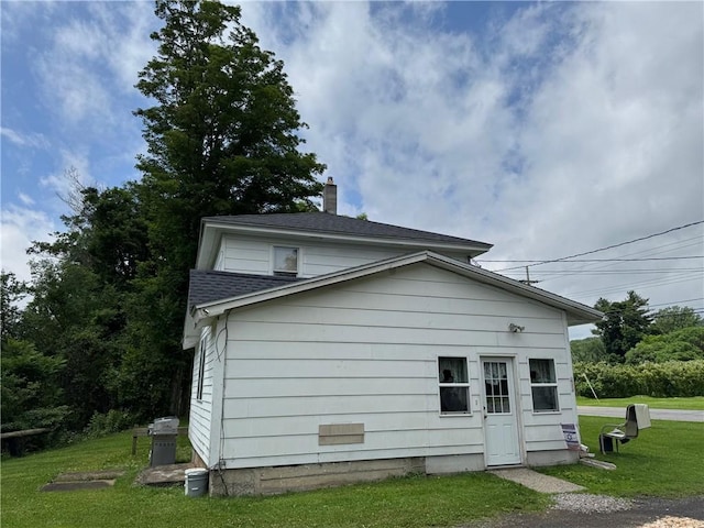 6463 County Road 20, Friendship, NY 14739 - view of home's exterior with a chimney, a yard, and a shingled roof