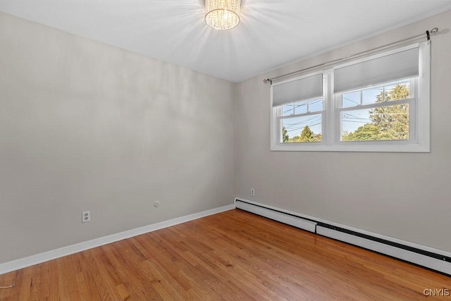 113 Craig Cir, Dewitt, NY 13214 - unfurnished room featuring baseboard heating, a chandelier, and light wood-type flooring