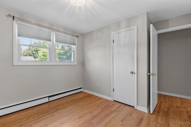 113 Craig Cir, Dewitt, NY 13214 - unfurnished bedroom with a baseboard radiator and light wood-type flooring