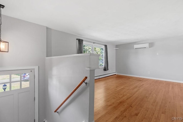 113 Craig Cir, Dewitt, NY 13214 - unfurnished room with a wall mounted AC, baseboard heating, and wood finished floors