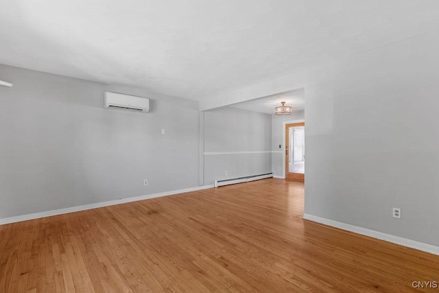 113 Craig Cir, Dewitt, NY 13214 - spare room featuring an AC wall unit, a baseboard heating unit, and light wood finished floors