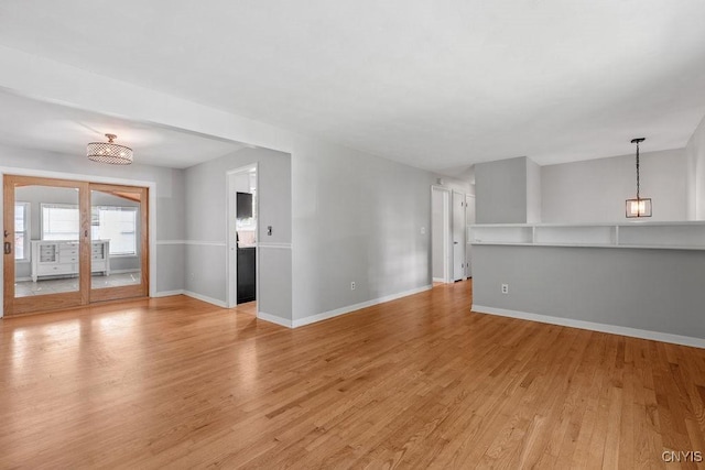 113 Craig Cir, Dewitt, NY 13214 - unfurnished room featuring light wood finished floors and a chandelier