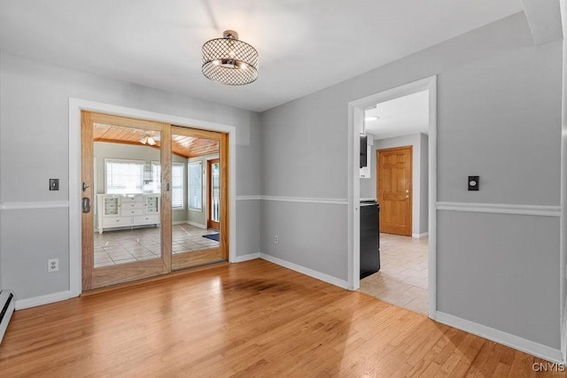 113 Craig Cir, Dewitt, NY 13214 - spare room featuring light wood-type flooring and a baseboard heating unit