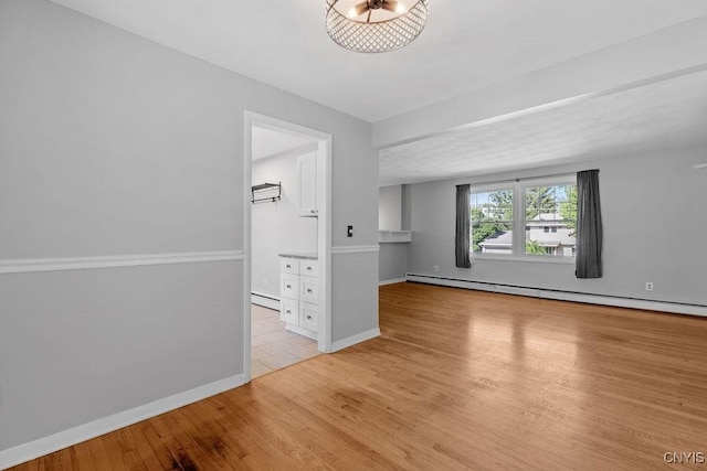 113 Craig Cir, Dewitt, NY 13214 - unfurnished room with light wood-type flooring and a baseboard radiator