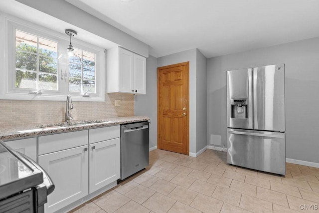 113 Craig Cir, Dewitt, NY 13214 - kitchen with stainless steel appliances, tasteful backsplash, white cabinets, light tile patterned flooring, and light stone counters