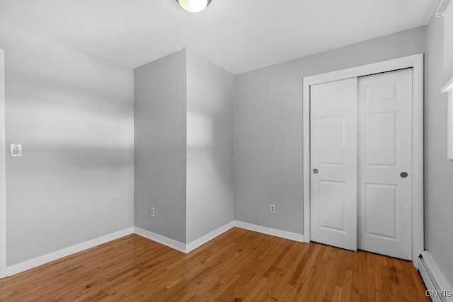 113 Craig Cir, Dewitt, NY 13214 - unfurnished bedroom featuring light wood-style floors, a closet, and baseboard heating