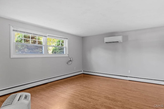 113 Craig Cir, Dewitt, NY 13214 - spare room with a wall mounted AC, wood finished floors, and a baseboard radiator