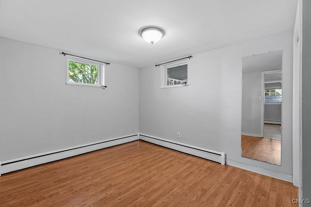 113 Craig Cir, Dewitt, NY 13214 - empty room with a baseboard heating unit, wood finished floors, and plenty of natural light