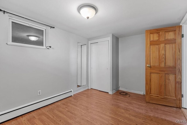 113 Craig Cir, Dewitt, NY 13214 - unfurnished bedroom with a baseboard heating unit, light wood-style flooring, and a closet