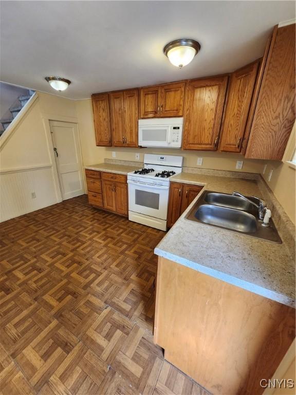 114 Stevens Pl, Syracuse, NY 13210 - kitchen with white appliances, light countertops, and brown cabinets