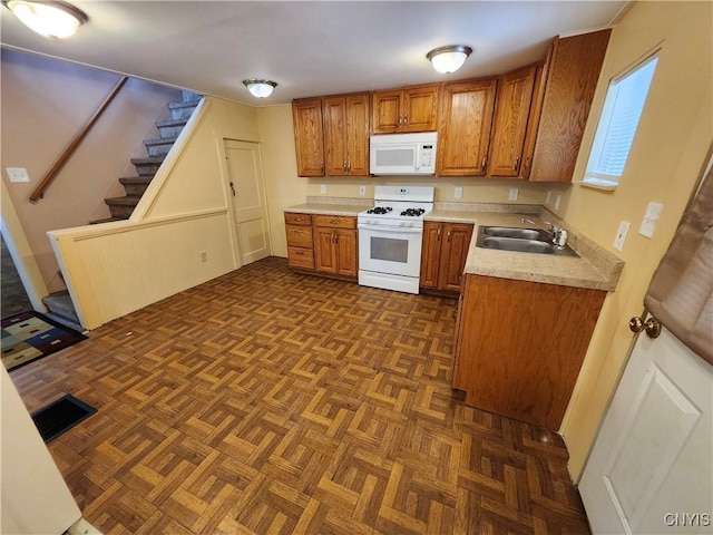 114 Stevens Pl, Syracuse, NY 13210 - kitchen featuring white appliances, brown cabinets, and light countertops