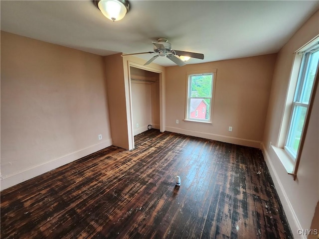 114 Stevens Pl, Syracuse, NY 13210 - unfurnished bedroom with dark wood-style flooring, a closet, and a ceiling fan
