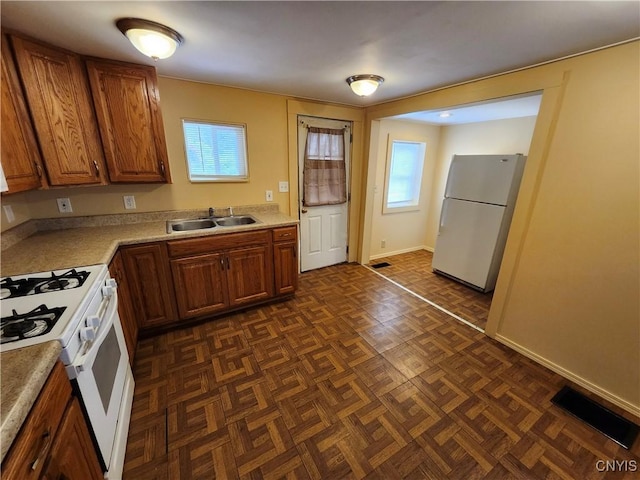 114 Stevens Pl, Syracuse, NY 13210 - kitchen with white appliances, brown cabinetry, and light countertops