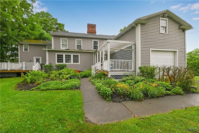 6188 Lake St, Aurelius, NY 13034 - rear view of property with a chimney, a wooden deck, a lawn, and a garage